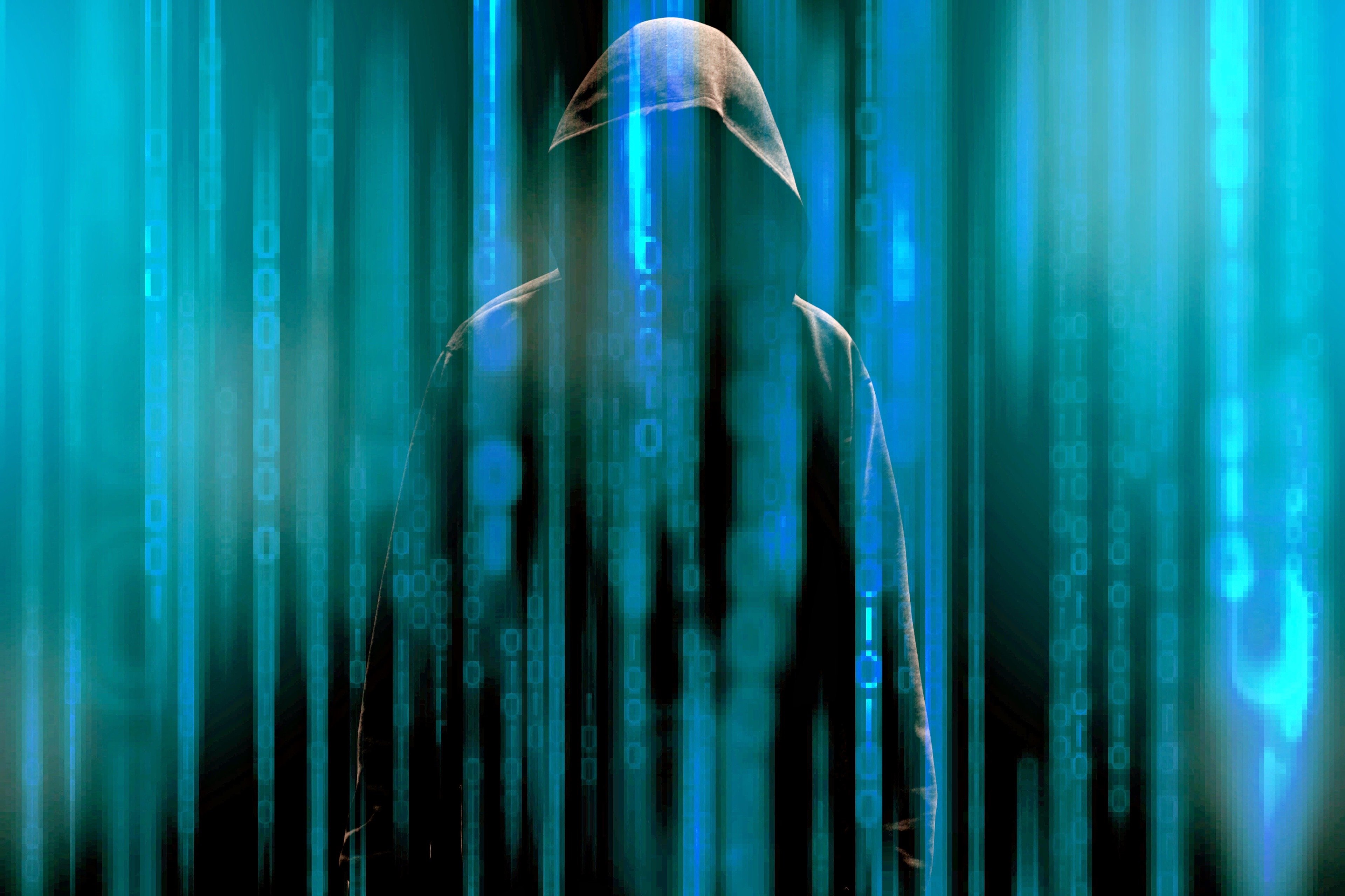 A hooded figure stands in front of a digital background with binary code, representing the concept of penetration testing