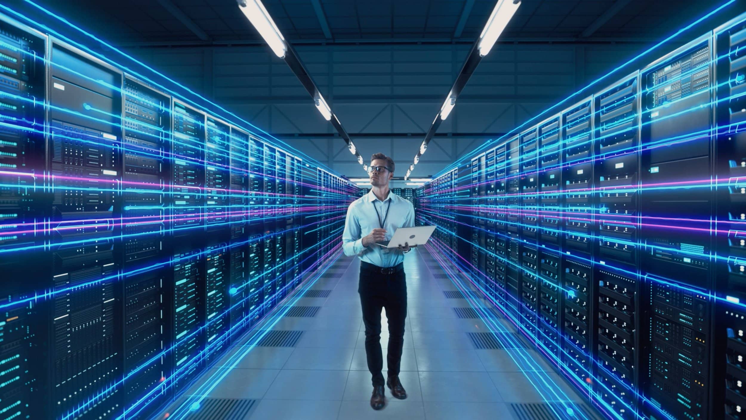 IT professional standing in a data center with rows of servers and glowing lights, representing the performance optimization services offered by Fast Fixx to ensure cloud resources are performing optimally and maximizing efficiency